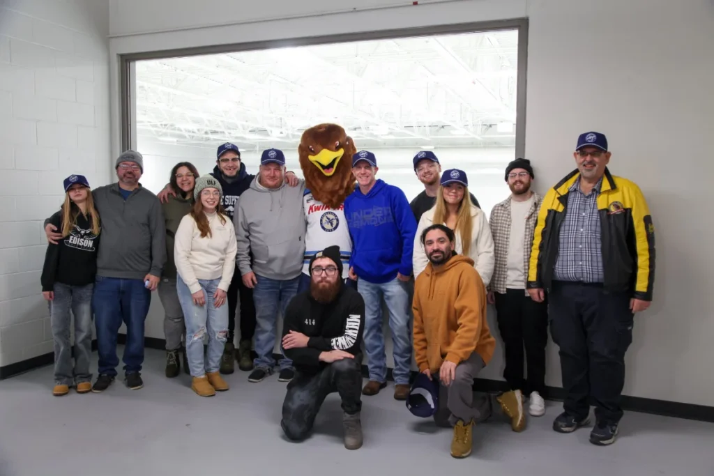 group photo at jets game with mascot