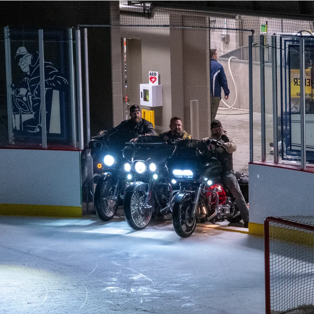 men driving motorcycles on ice
